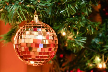 Close up of the glitter ball decoration on the Christmas tree with LED lights.の写真素材