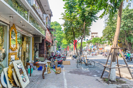 Local daily life of the street and view of busy traffic with motorbikes and vehicles in Hanoi Old Quarter, capital of Vietnam.のeditorial素材