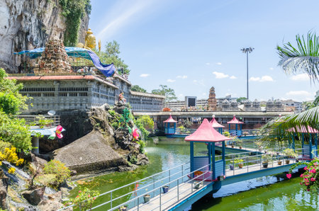 Kuala Lumpur, Malaysia - Feb 13, 2018 : CAVE Villa is a new tourism attraction in Batu Caves. It restored Koi Pond boasts a stretch of Balinese bridge that travels across the pond with Koi Fishes.のeditorial素材