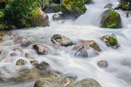 Waterfall in Lake Marian which is located in the Fiordland National Park, Milford sound, New Zealand.の写真素材