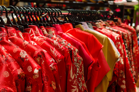 Colorful chinese cheongsam hanging for sale during Chinese New Year.の写真素材
