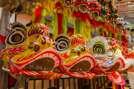 Traditional chinese lion dance head display on the shelves.の写真素材
