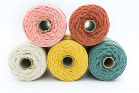 Close-up view of the colorful single strand cotton cords for macrame DIY handcraft on white background.の写真素材