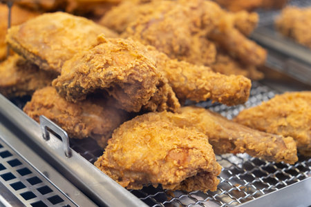 Close up view of the crispy fried chicken on the tray for saleの写真素材