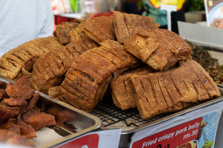 Close-up view of the fried crispy pork belly selling in the bazaar.