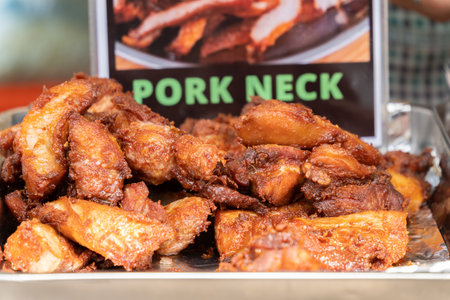 Deep fried pork neck selling at the food stall in the bazaar.の写真素材