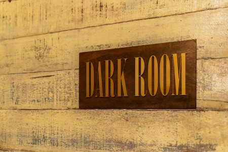 Close-up view of a signboard of Dark Room on the wooden wall.の写真素材