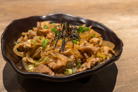Close-up view of the Japanese cuisine Donburi chicken rice with egg ,seaweed and onion.の写真素材