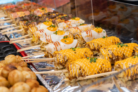 Close-up view of a delicious Okonomiyaki Sticks selling at the food stall.の写真素材