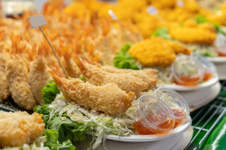 Breaded prawn with chili sauce. It features prawns that are coated in a crispy, golden-brown...