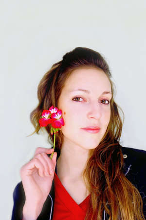 Special look of a woman with flower geraniumの写真素材