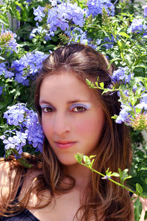 Woman with blue flowers blue makeup betweenの写真素材