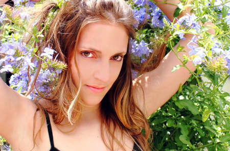 Beautiful woman in blue flowersの写真素材