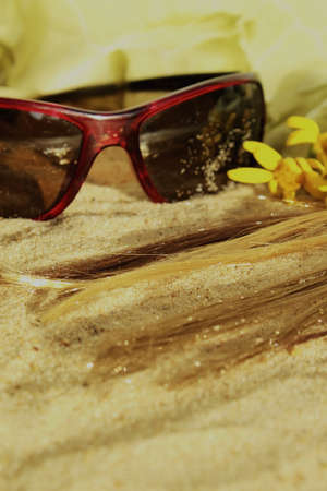 hair in the sand and eyeglasses