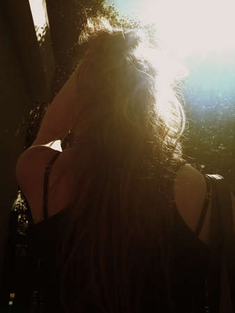 woman backlit by sun の写真素材