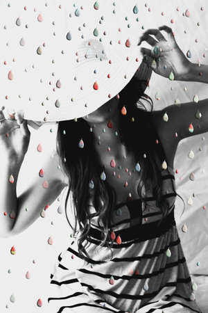 Woman under shower of colored dropsの写真素材