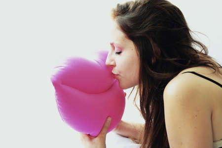 happy woman kissing pink mouthの写真素材