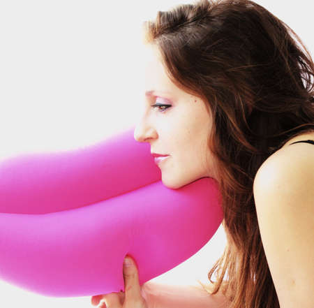 Happy woman lying on pillowの写真素材