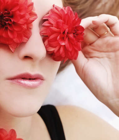 woman with flowers over eyes の写真素材