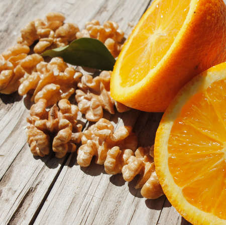 oranges and walnuts on the tableの写真素材