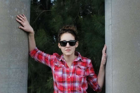 young woman posing with sunglasses の写真素材