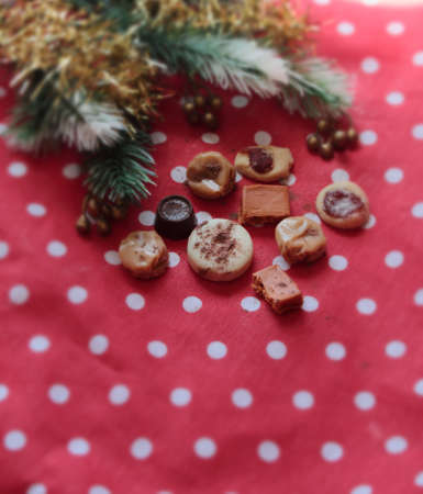table with tablecloth spot with chocolates and chocolate candiesの写真素材