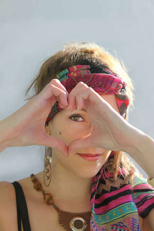 Woman doing a heart with handsの写真素材