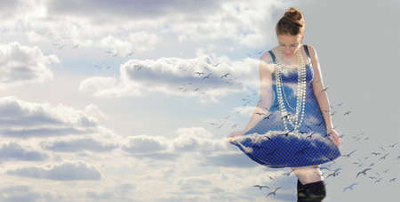 woman in the clouds and birdsの写真素材