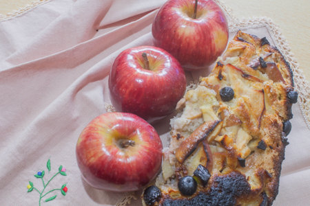 Apple pie with apples and blueberries on a linen napkin.の写真素材