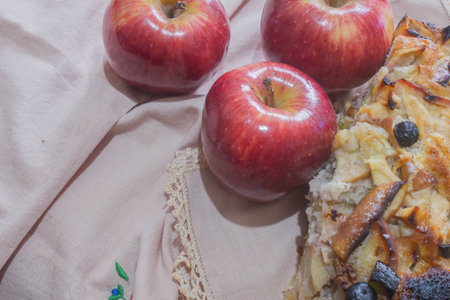 Apple pie with raisins and apples on a linen tableclothの写真素材