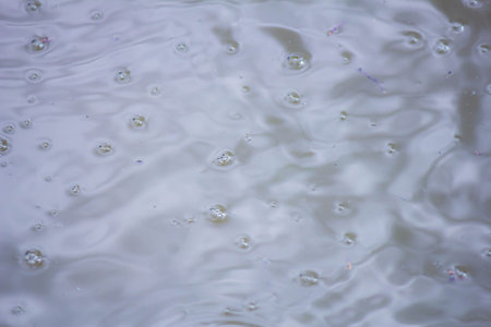 Water surface with bubbles, shallow depth of field, selective focus.