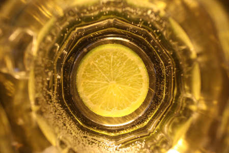slice of lime in a glass of waterの写真素材
