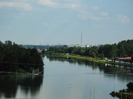 Water dam with city buildings on the horizon