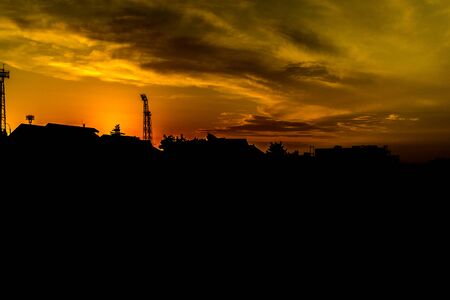 Sun setting over the stadium with residential area in the foregroundの写真素材