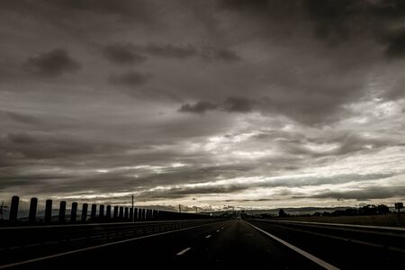 Two lanes highway in a gloomy overcast sceneryの写真素材