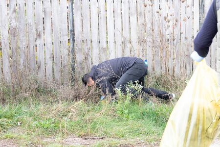 Man gathering litter from natureの写真素材