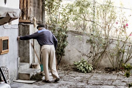 Old man walking towards the stairsの写真素材