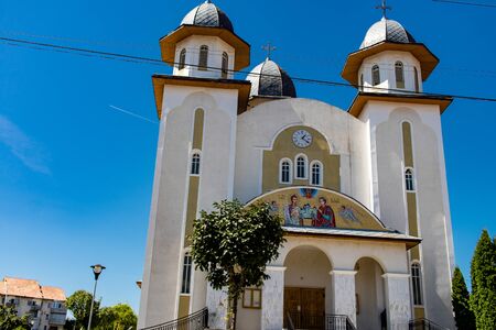 Upwards view of a white church on a clear blue sky day