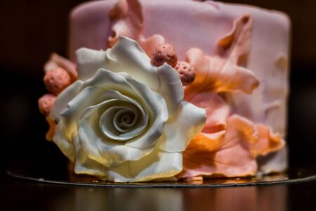 Closeup of a white rose decoration on a birthday cake