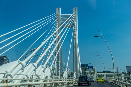 Cars passing on a modern bridgeの写真素材
