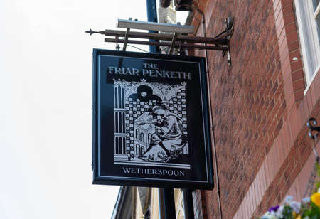 The exterior mount pub sign outside The Friar Penketh public house part of the Wetherspoon chain of...