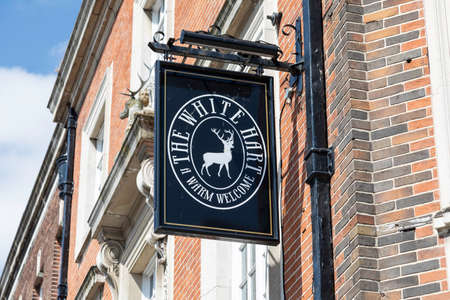 An exterior mounted pub sign for The White Hart public house in Warrington Cheshire May 2018のeditorial素材