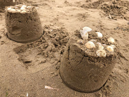 Sandcastles decorated with the shells on the beach, Hoylake, Wirral