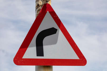 triangular road sign indicating sharp right bend Wirral June 2019