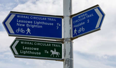 Blue and black signs for footpaths and cyclepaths at Leasowe Wirral England June 2019