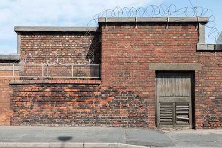 Exterior of brick building with barbed wire in Wallasey Wirral August 2019のeditorial素材
