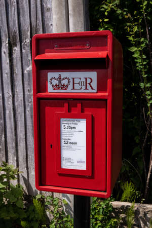 Small mounted modern red post box in Upton Wirral May 2020