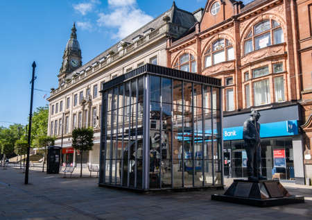 Statue of Fred Dibnah with town hall in background in Bolton Lancashire July 2020