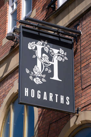 Sign for Hogarths public house in the town centre in Bolton Lancashire July 2020