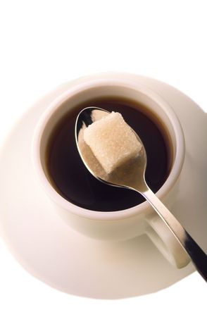 cup of coffee on  plate with  dessertspoon and one slice of sugar on white backgroundの写真素材